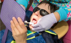 The patient with special needs gets dental treatment.